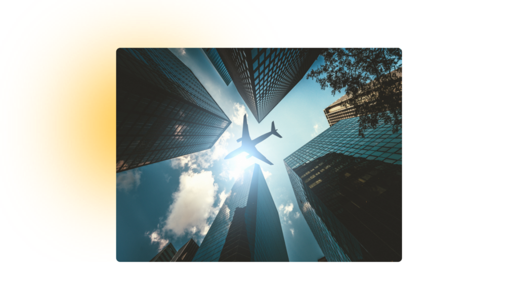 Plane flying over some buildings